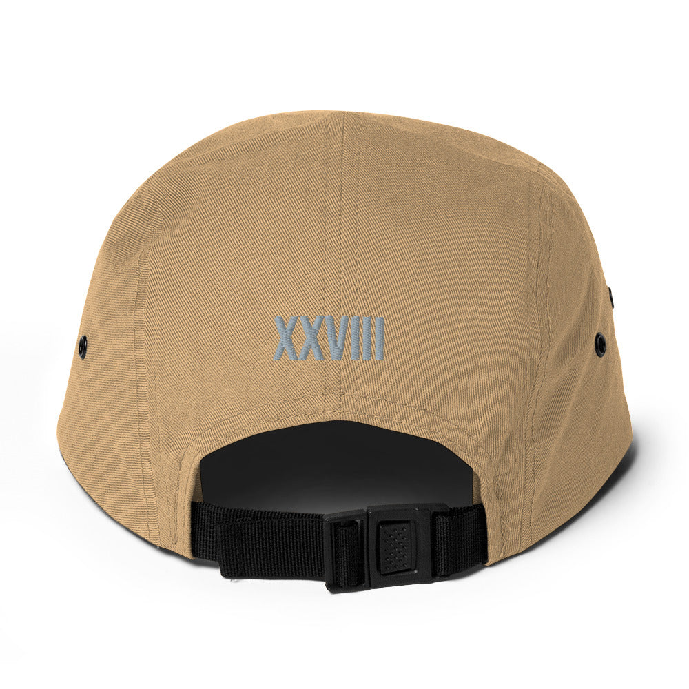 Beige cap with black buckle and 'XXVIII' embroidery on a white background
