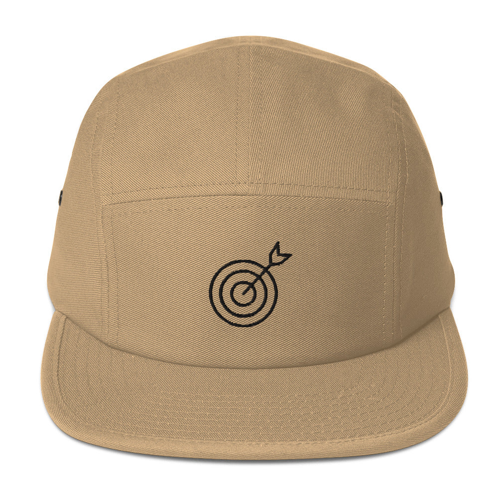 Beige cap with a black target and arrow design on a white background