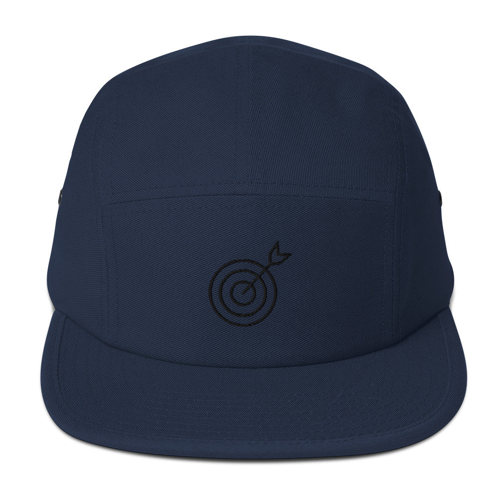 Navy blue cap with a black target and arrow design on a white background