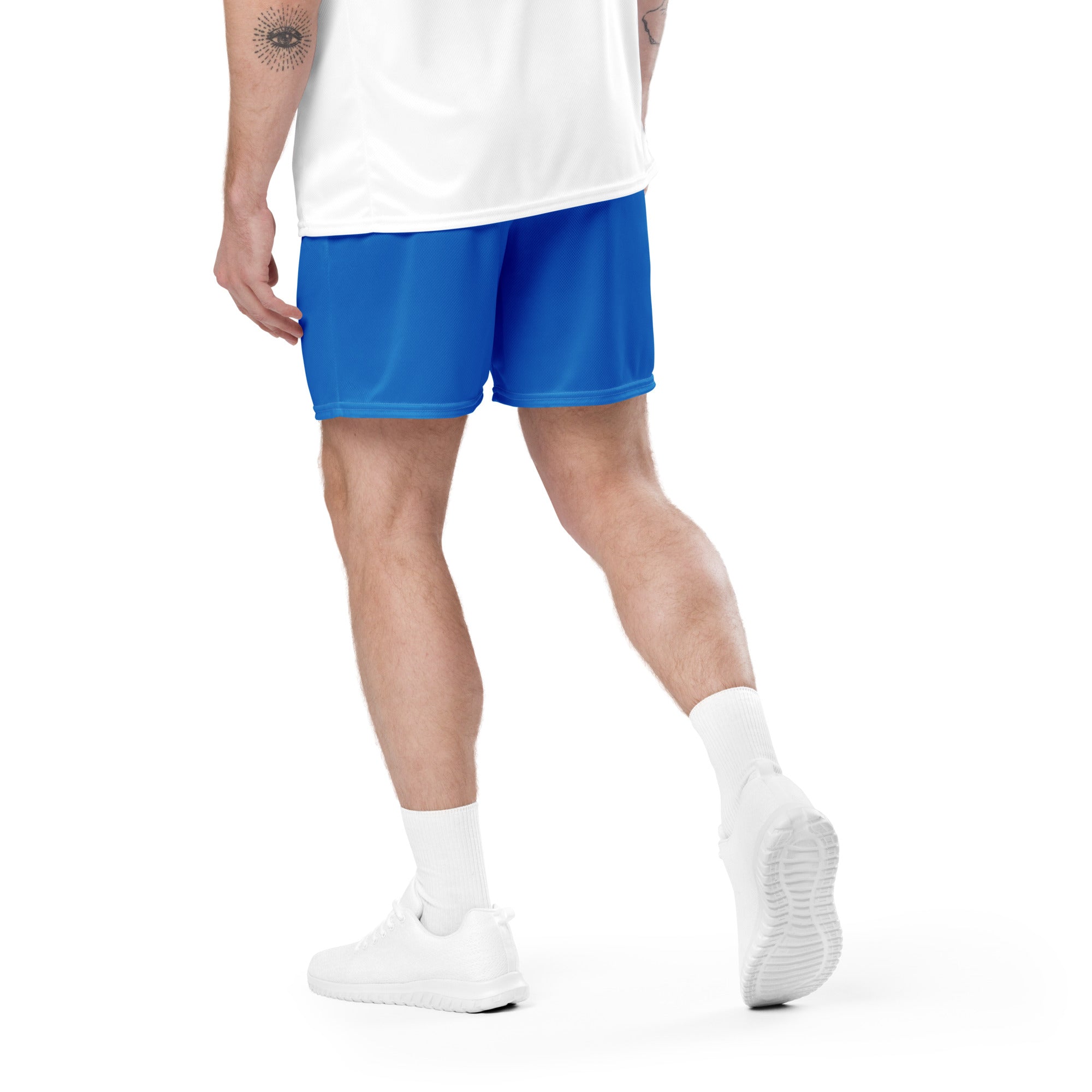Person wearing blue shorts and white shoes on a white background