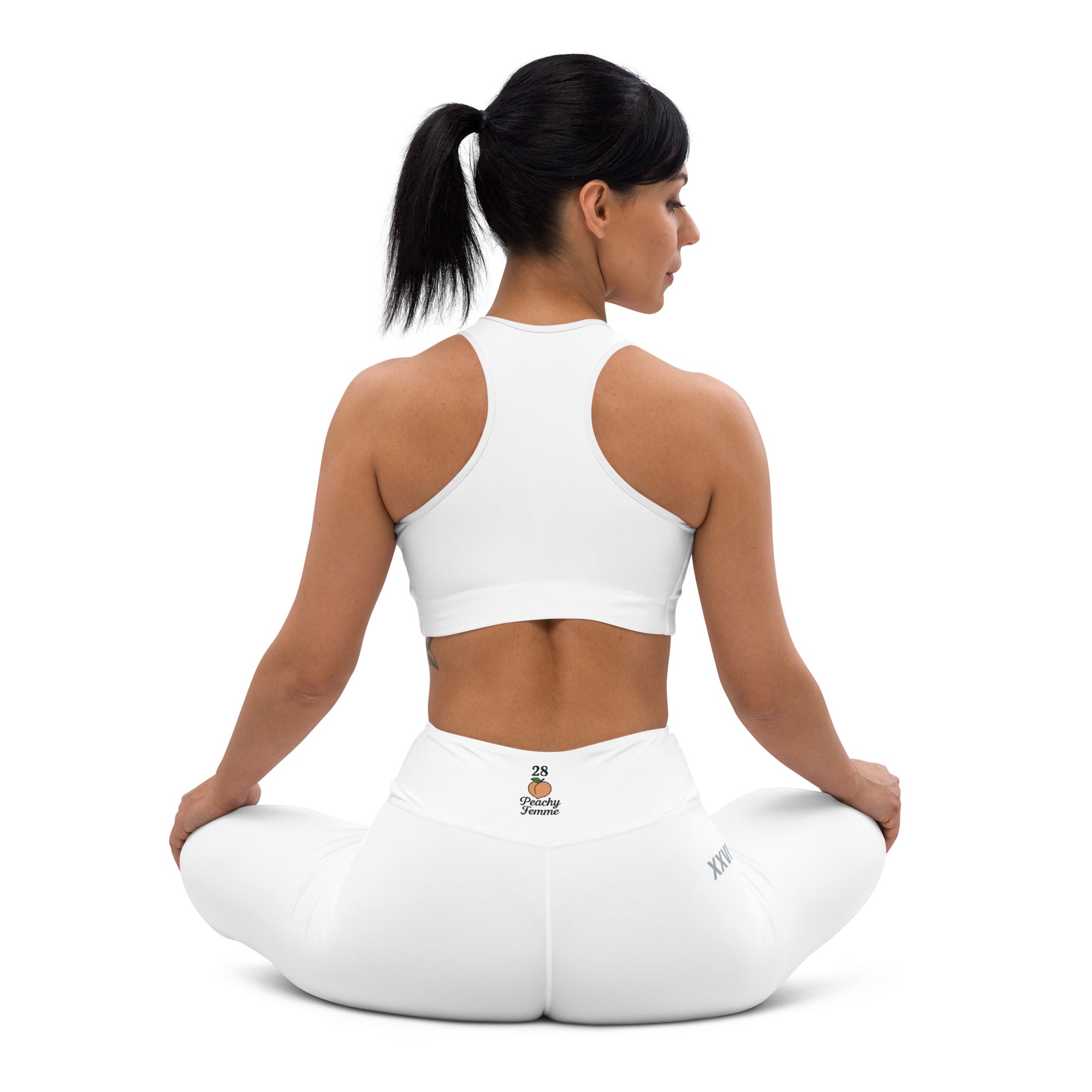 Woman sitting on a white yoga pillow with a white background