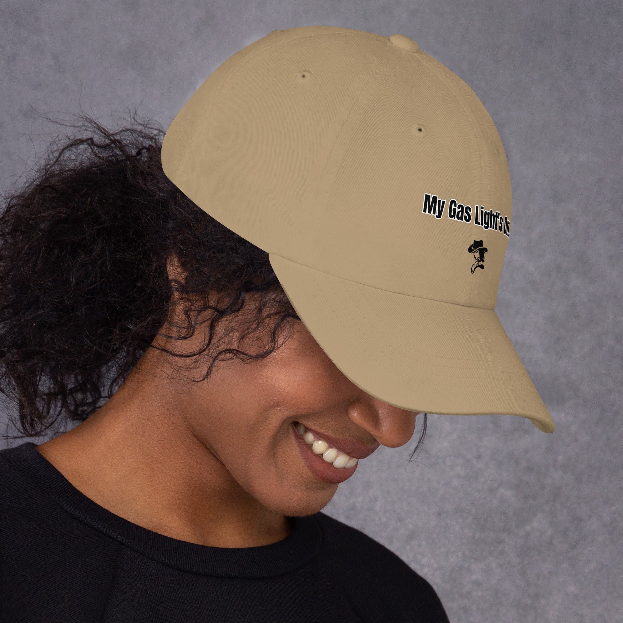 Person wearing a beige cap with text and logo on a gray background