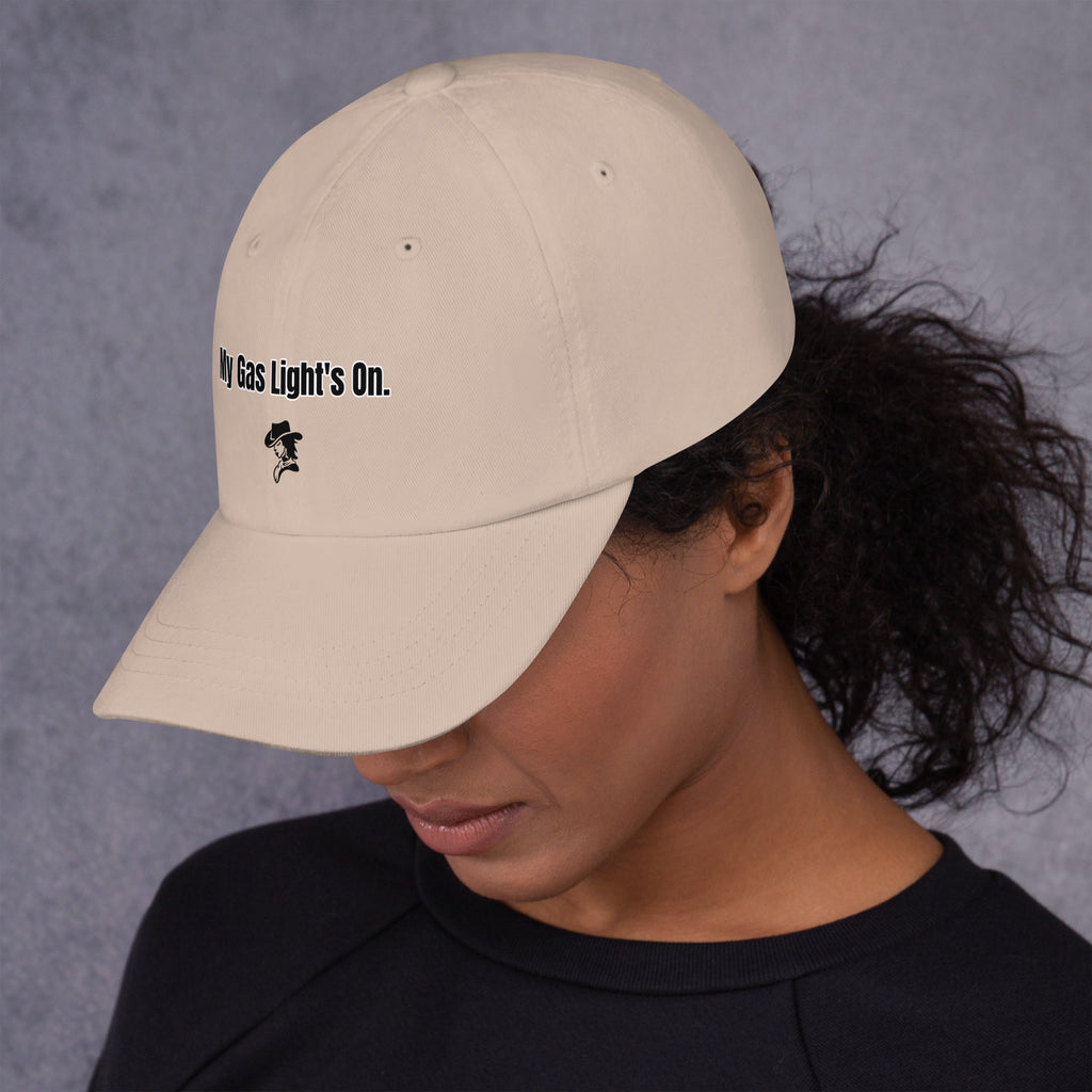 Person wearing a beige cap with text and a logo on a gray background