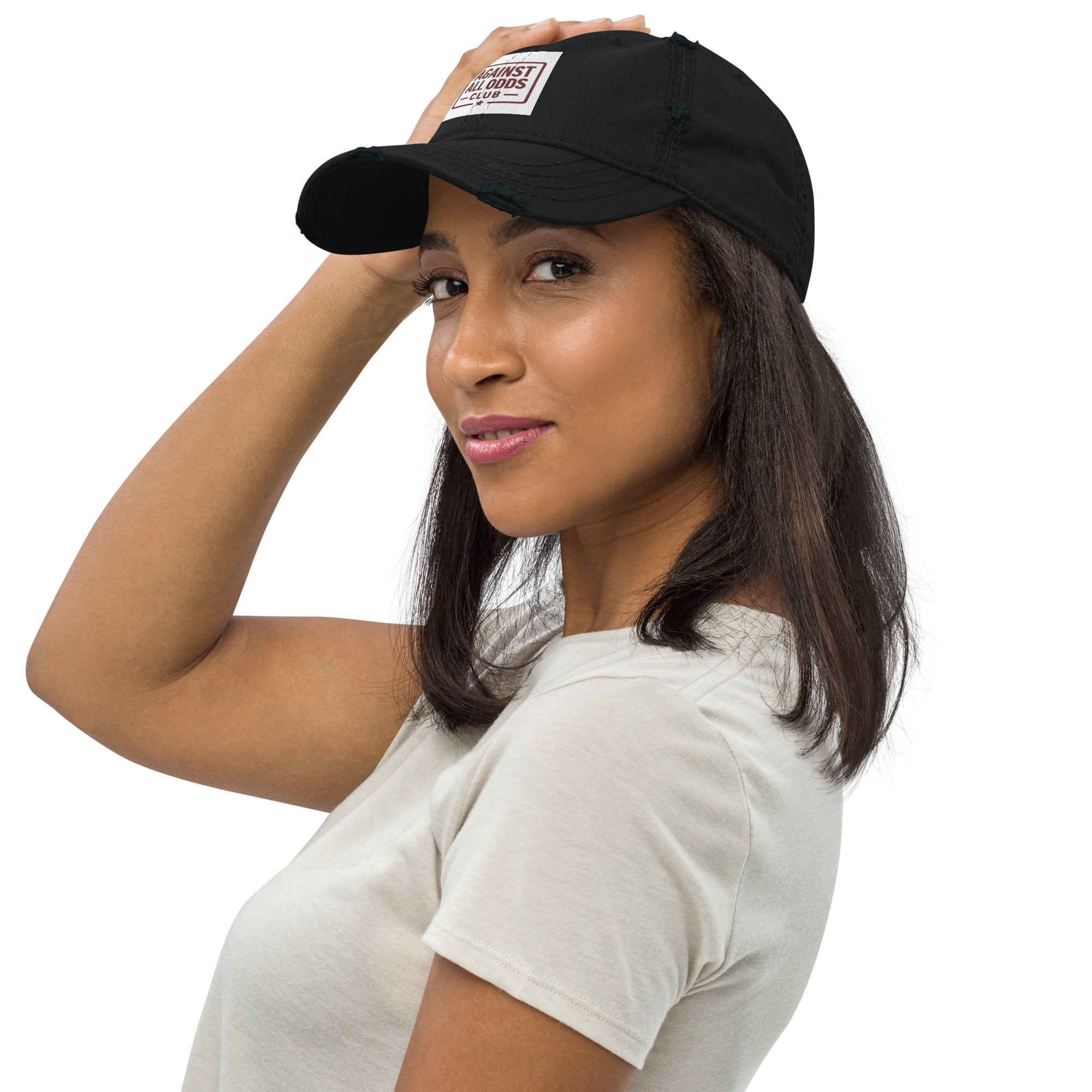 Woman wearing a black cap with a visible brand logo on a white background