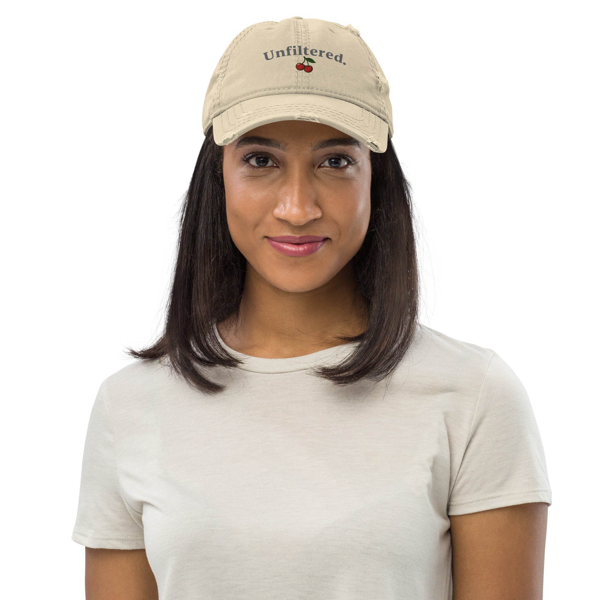 Person wearing a beige cap with 'Unfiltered' text and cherry graphic on a white background