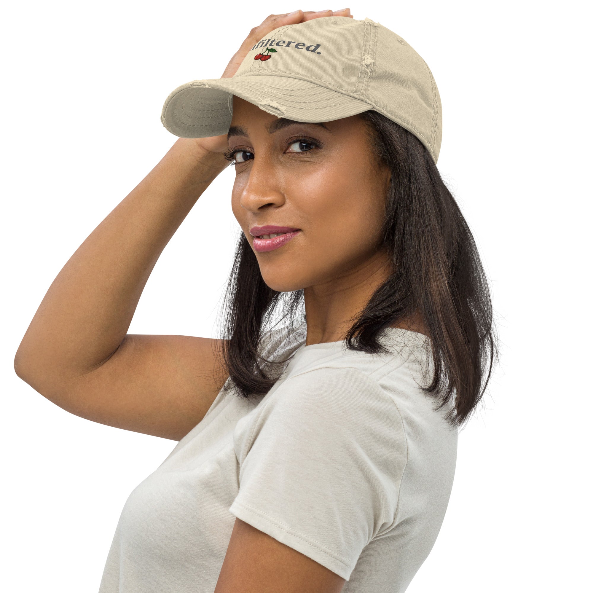 Woman wearing a beige cap with text and a logo on a white background