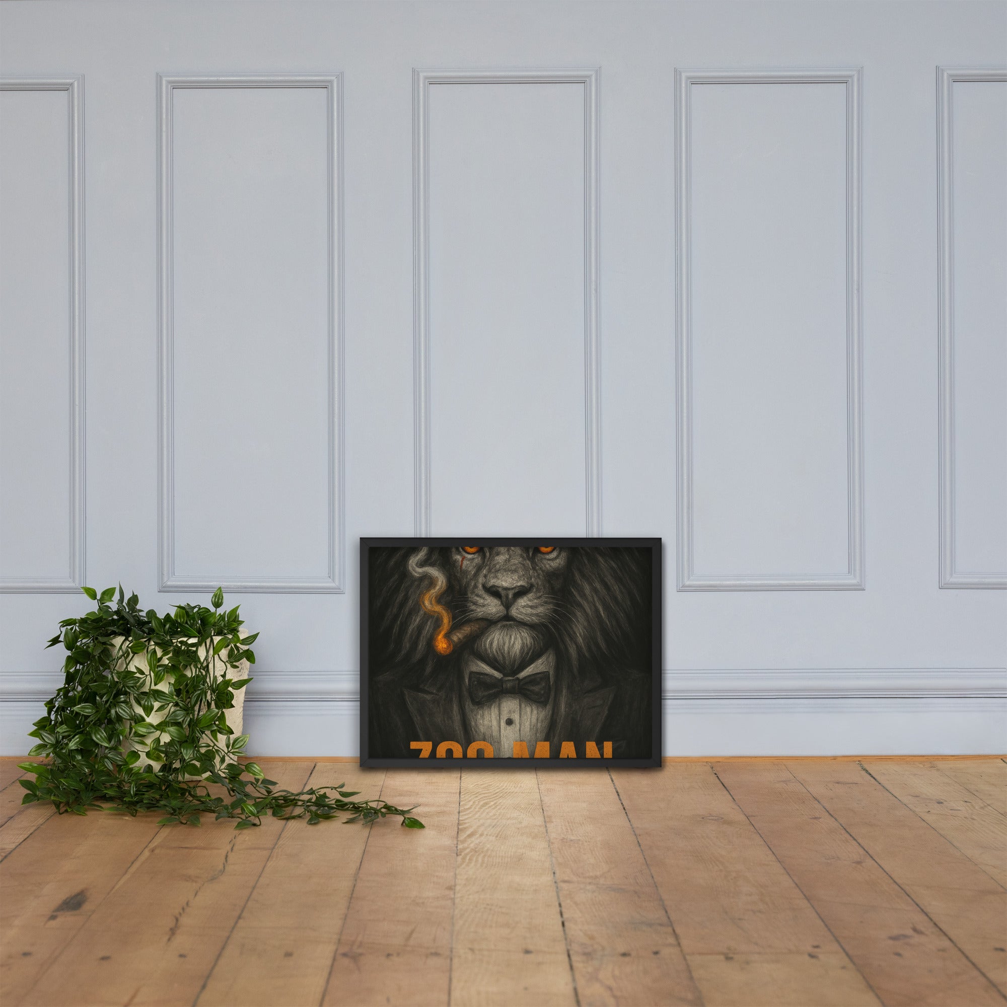 Framed artwork of a lion with a bow tie on a wooden floor against a white paneled wall.