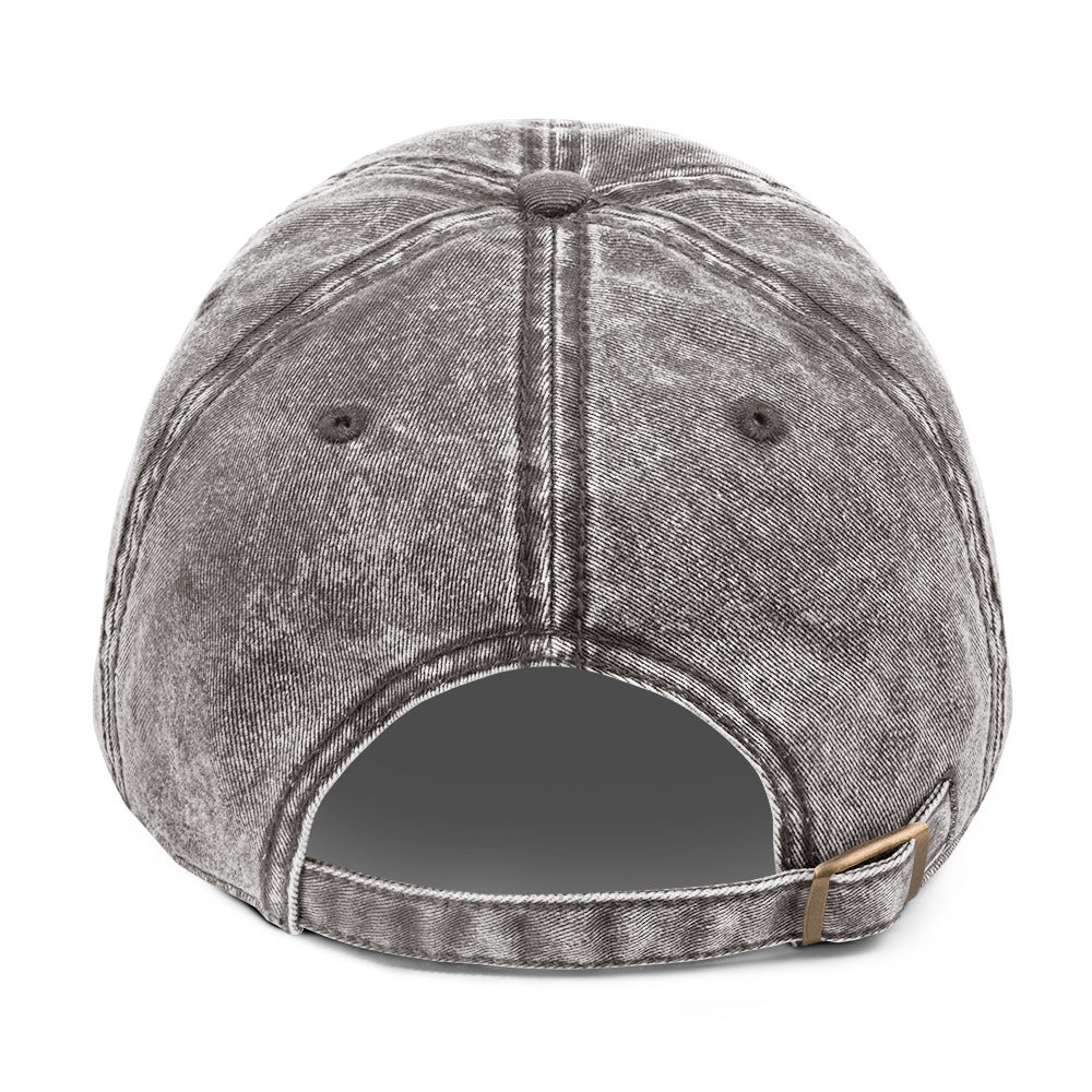 Gray denim cap with leather strap on a white background